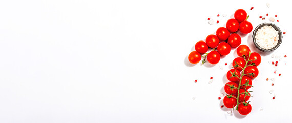Cooking background with tomato cherry, sea salt, and rose peppercorn isolated on white background