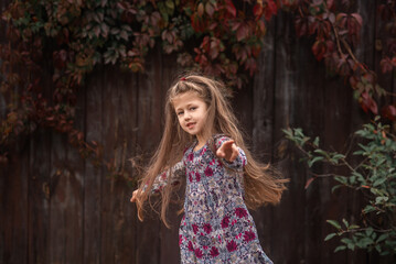 Fototapeta na wymiar girl with long hair is dancing in autumn park 