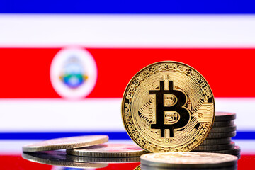  Gold metal coin Bitcoin on the background of the flag of  Costa Rica  . Concept for investors in...