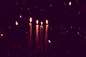 four advent candles burning on advent wreaths