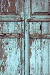 Texture of old wooden door with peeling blue paint