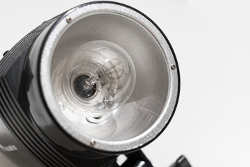 lamp in the Studio flash on a white background. Compact flash designed for work in the studio and on the road for shooting portraits and photos on documents.