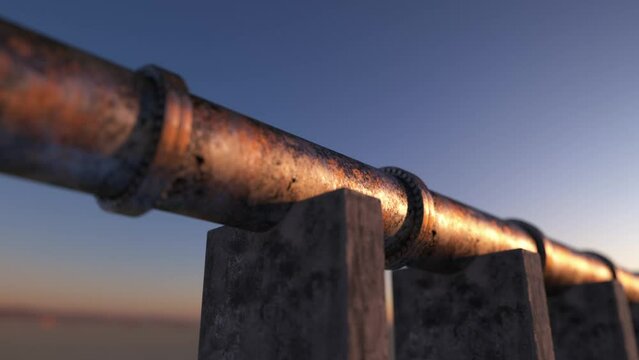 old pipe over concrete foundation at sunset
