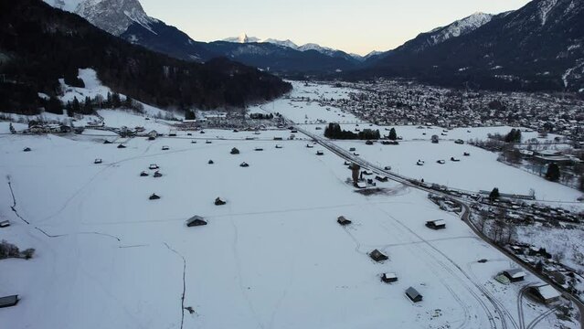 4K aerial of Garmisch Partenkirchen in the alps of Bavaria, Germany in the winter snow