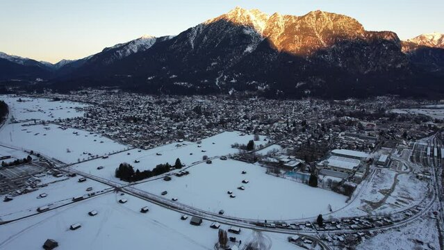 4K aerial of Garmisch Partenkirchen in the alps of Bavaria, Germany in the winter snow
