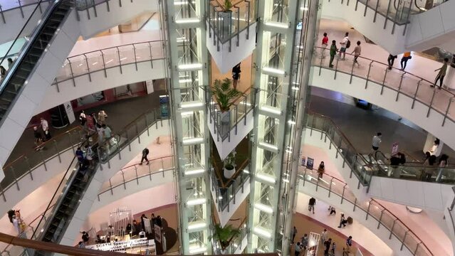 Bangkok, Thailand Monday 10 October 2022 at 14:00 pm People are shopping in a large shopping mall in the middle of the capital city of Thailand.  Use the escalators to go up each floor of the departme