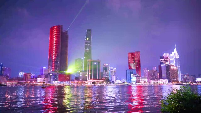 view of Bitexco and IFC One Tower, buildings, roads and Saigon river in Ho Chi Minh city - Laser and lighting show displayed. Travel and landscape concept.