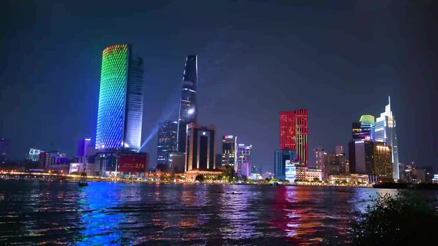 view of Bitexco and IFC One Tower, buildings, roads and Saigon river in Ho Chi Minh city - Laser and lighting show displayed. Travel and landscape concept.