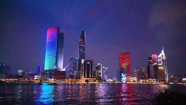 view of Bitexco and IFC One Tower, buildings, roads and Saigon river in Ho Chi Minh city - Laser and lighting show displayed. Travel and landscape concept.