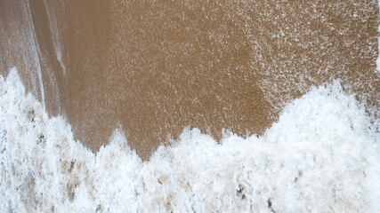 Sea waves blow on the sandy beach. for background