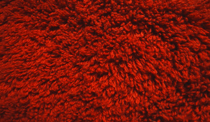 Texture of red soft terry towel textile.