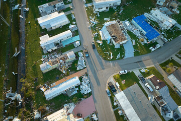 Severely damaged by hurricane Ian houses in Florida mobile home residential area. Consequences of...