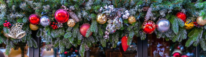 Banner with Christmas toys on a green tree on black background