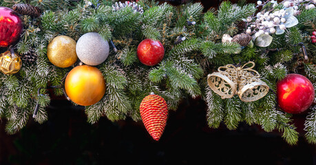 Banner with Christmas toys on a green tree on black background
