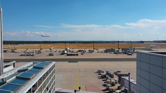The Frankfurt airport with an airplane landing on a sunny day.