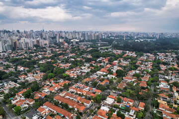 Rainy day in the Jardins neighborhood located in the city of São Paulo, capital. Dark clouds, buildings, cars, trees and pedestrians circling.