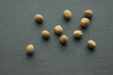 whole nutmeg on black background spices spices top view layout space for text ingredients for cooking oriental