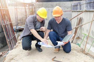 Construction concept of Engineer and Architect working at Construction Site with blue print