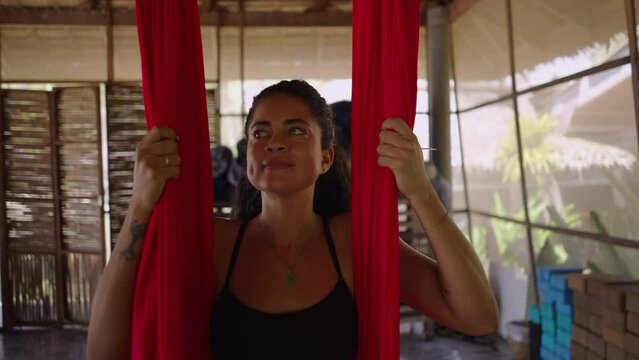Athletic young woman laying in corpse pose in yoga session at Thai healing center 