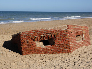 World War Two pill box defences sunk into sandy beach