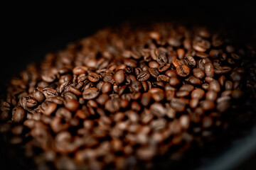 Close up machine spatula with brown arabica coffee beans near special equipment. Factory concept.