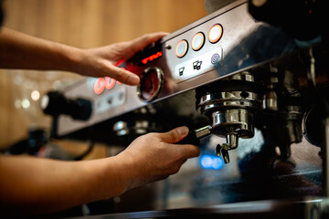 Preparing fresh coffee. Closeup of tamping Fresh Ground Coffee.