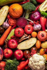 assortment of assorted fruits and vegetables harvest on a vertical rustic background. Apples vitamins healthy food antioxidants