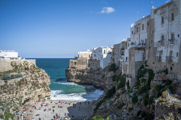 Fototapeta na wymiar Spectacular houses of the old town of Polignano a Mare built on the cliffs above the Adriatic Sea view from the sea on a beautiful sunny day