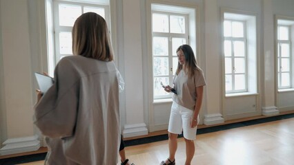 Creative female art team decorators discussing wedding preparation woman customer decor arrangement