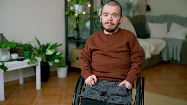 Portrait of young amn with disability sitting in wheelchair