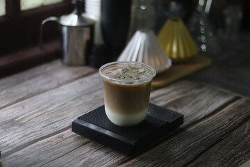 Closeup of Iced Caramel Macchiato at the coffee shop, Caramel Macchiato is a classic macchiato beverage. It consists of vanilla syrup, espresso, steamed milk, foam, and caramel drizzle