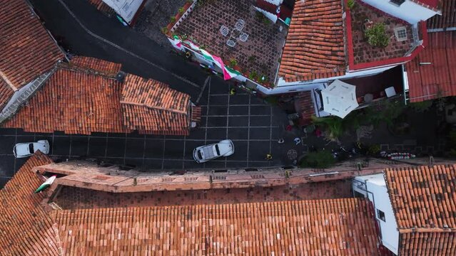Vehicles and people on tight streets of Taxco Guerrero, Mexico - cenital, aerial view