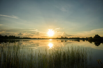 Beautiful view of sunrise over the lake in park, Thailand