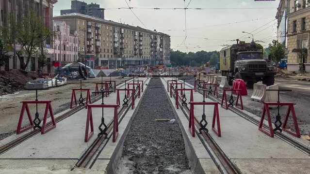 Tram rails at the final stage of their installation and integration into concrete plates on the road timelapse. Filling by liquid resin for reduction from vibration and noice. The process of