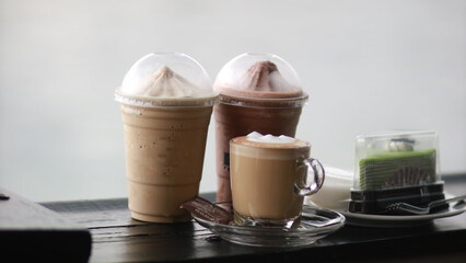 Closeup of Iced Caramel Macchiato at the coffee shop, Caramel Macchiato is a classic macchiato beverage. It consists of vanilla syrup, espresso, steamed milk, foam, and caramel drizzle
