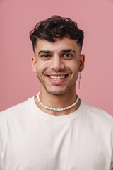 Fototapeta premium Young handsome stylish smiling man with piercing in necklace