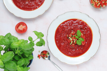 Plates with traditional gazpacho tomato soup