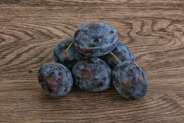 Ripe plum heap over background