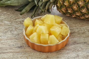 Marinated pineapple slices in the bowl