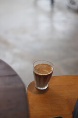 dirty coffee iced latte freeze milk pour espresso shot in a cup of coffee on scale measurement wooden bar table cafe in thailand asia by barista workout