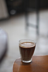 dirty coffee iced latte freeze milk pour espresso shot in a cup of coffee on scale measurement wooden bar table cafe in thailand asia by barista workout