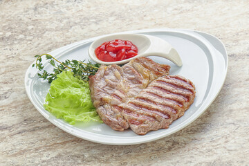 Grilled pork neck steak with ketchup