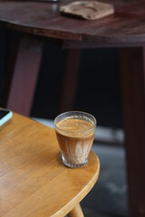 dirty coffee iced latte freeze milk pour espresso shot in a cup of coffee on scale measurement wooden bar table cafe in thailand asia by barista workout