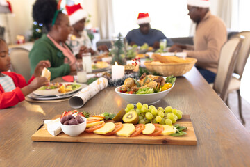 African american family spending time together at the table having a christmas meal