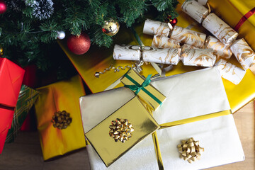 Many different colorful christmas presents with ribbons under the christmas tree