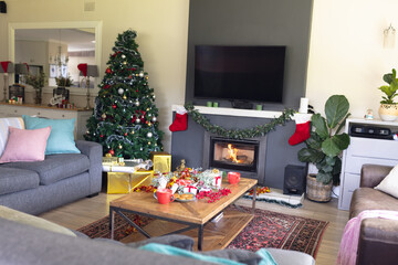 A modern living room decorated with christmas decorations, a christmas tree and gifts