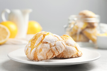 Plate with delicious lemon cookies on table, closeup