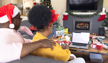 African american couple having face time and using laptop with copy space