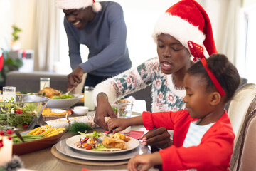 Happy african american family spending time together having christmas meal
