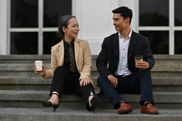 Coffee break and chill out after work with Senior businesswoman and Young smart businessman sitting...